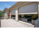 Enclosed patio with roll down sunscreens reveals a comfortable outdoor living lounge with a fire pit at 16913 W Holly St, Goodyear, AZ 85395