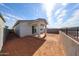 An exterior shot showcasing a cozy covered patio and enclosed backyard, creating a private outdoor space at 17290 W Daley Ln, Surprise, AZ 85387