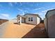 Lovely backyard featuring a covered patio, slider to the home, and block wall for privacy at 17290 W Daley Ln, Surprise, AZ 85387