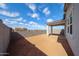 Spacious backyard with covered patio and block wall fencing, perfect for outdoor living and entertaining at 17290 W Daley Ln, Surprise, AZ 85387