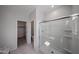 Bathroom featuring a shower with sliding glass door and a view into a closet at 17290 W Daley Ln, Surprise, AZ 85387