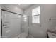 Close up on bathroom shower with built in seats, window and chrome hardware at 17290 W Daley Ln, Surprise, AZ 85387