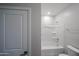 Bathroom featuring a tub/shower, toilet, and chrome hardware at 17290 W Daley Ln, Surprise, AZ 85387