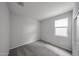 Neutral bedroom has carpeted floor, window, and closet at 17290 W Daley Ln, Surprise, AZ 85387