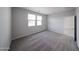 Carpeted bedroom features window and closet at 17290 W Daley Ln, Surprise, AZ 85387