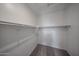 View of walk-in closet with carpet flooring and installed closet rods for storage at 17290 W Daley Ln, Surprise, AZ 85387