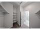 View into closet and bathroom with shelving for storage and organization solutions at 17290 W Daley Ln, Surprise, AZ 85387