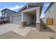 Charming exterior elevation featuring a two-car garage, desert landscaping, and inviting front porch at 17290 W Daley Ln, Surprise, AZ 85387