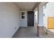Inviting covered entryway with a dark front door and brick-accented columns at 17290 W Daley Ln, Surprise, AZ 85387
