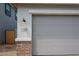 Close up of a large two car garage and lovely brick accent at 17290 W Daley Ln, Surprise, AZ 85387
