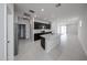 Open-concept kitchen with dark cabinets, granite countertops, and stainless steel appliances at 17290 W Daley Ln, Surprise, AZ 85387