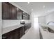 New kitchen showcases granite countertops, dark cabinets, subway tile backsplash, and stainless appliances at 17290 W Daley Ln, Surprise, AZ 85387