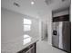 Modern kitchen featuring stainless steel appliances and a large granite island at 17290 W Daley Ln, Surprise, AZ 85387