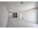 Spacious, bright living room with tile floors and an open layout to the kitchen at 17290 W Daley Ln, Surprise, AZ 85387