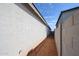 Long side yard with block fence and desert landscaping at 17290 W Daley Ln, Surprise, AZ 85387