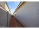 Photo of the side yard between homes featuring privacy walls and desert landscaping at 17290 W Daley Ln, Surprise, AZ 85387
