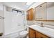 Functional bathroom with a shower-tub combination, vanity, and mirrored cabinet at 1827 W Bluefield Ave, Phoenix, AZ 85023