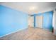 Bright bedroom with tile flooring, ample closet space, and soothing light blue walls at 1827 W Bluefield Ave, Phoenix, AZ 85023
