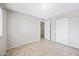 Simple bedroom with neutral walls, tile flooring, and a closet at 1827 W Bluefield Ave, Phoenix, AZ 85023