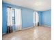 Inviting bedroom featuring tile flooring, ample natural light, and light blue painted walls at 1827 W Bluefield Ave, Phoenix, AZ 85023