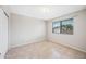 Cozy bedroom with tile flooring, a large window, and a closet for storage at 1827 W Bluefield Ave, Phoenix, AZ 85023
