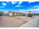 Single story home featuring desert landscaping, a brick accent, and a light colored exterior at 1827 W Bluefield Ave, Phoenix, AZ 85023