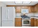 Kitchen featuring stainless steel appliances, wooden cabinets, and a light colored countertop at 1827 W Bluefield Ave, Phoenix, AZ 85023
