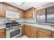 Up-close kitchen view showcasing stainless steel appliances, wood cabinets, and a large sink at 1827 W Bluefield Ave, Phoenix, AZ 85023