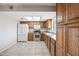 Kitchen showcasing stainless steel appliances, wooden cabinets, and a light colored countertop at 1827 W Bluefield Ave, Phoenix, AZ 85023