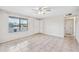 Bright living room with tile floors, a ceiling fan, and a large window for natural light at 1827 W Bluefield Ave, Phoenix, AZ 85023