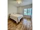 Bedroom features a cozy queen bed, wood floors and a bright window for natural light at 19400 N Westbrook Pkwy # 216, Peoria, AZ 85382