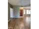 Open-concept living area with wood flooring, great natural light, and entry to the kitchen at 19400 N Westbrook Pkwy # 216, Peoria, AZ 85382