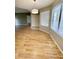 Spacious living room with wood floors, modern lighting, and lots of natural light at 19400 N Westbrook Pkwy # 216, Peoria, AZ 85382