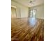 Bright living room features wood flooring and sliding doors to a private balcony at 19400 N Westbrook Pkwy # 216, Peoria, AZ 85382