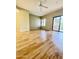 Bright living room with wood flooring and a sliding glass door leading to the balcony at 19400 N Westbrook Pkwy # 216, Peoria, AZ 85382