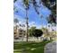 Exterior view of the community, featuring a pool, garden and tall palms under the sky at 19400 N Westbrook Pkwy # 216, Peoria, AZ 85382