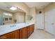 Spacious bathroom featuring double vanity, large mirror, and tile flooring at 21003 N Circle Cliffs Dr, Surprise, AZ 85387