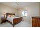 Cozy bedroom features ceiling fan, neutral carpet, and ample natural light at 21003 N Circle Cliffs Dr, Surprise, AZ 85387