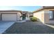 Charming home with desert landscaping, a two-car garage, and a quaint gated front entrance at 21003 N Circle Cliffs Dr, Surprise, AZ 85387