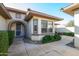 Inviting front porch with an arched entrance, security door, and charming outdoor seating area at 21003 N Circle Cliffs Dr, Surprise, AZ 85387