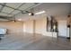 Spacious garage with concrete flooring, neutral paint, ample lighting, and attached water heater at 21003 N Circle Cliffs Dr, Surprise, AZ 85387