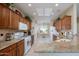 Well-lit kitchen boasts granite countertops, wood cabinets, and modern appliances at 21003 N Circle Cliffs Dr, Surprise, AZ 85387