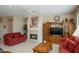 Cozy living room featuring a fireplace, ceiling fan, and comfortable seating at 21003 N Circle Cliffs Dr, Surprise, AZ 85387