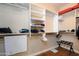 Spacious walk-in closet with custom shelving for organization and ample storage at 21003 N Circle Cliffs Dr, Surprise, AZ 85387