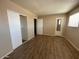 Bright bedroom featuring wood floors, closet, and neutral color palette at 2133 W Turney Ave # C88, Phoenix, AZ 85015