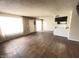 Spacious living room featuring wood floors, large windows, and a convenient breakfast bar to the kitchen at 2133 W Turney Ave # C88, Phoenix, AZ 85015