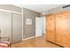Bedroom showcasing hardwood floors, a large armoire, and a closet at 2201 N Central Ave # 3D, Phoenix, AZ 85004