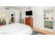 Bedroom featuring a television, dresser, a view into the bathroom, and a sliding door mirrored closet at 2201 N Central Ave # 3D, Phoenix, AZ 85004