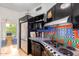 Unique kitchen boasts custom tile, black cabinetry, stainless steel appliances, and stylish design at 2201 N Central Ave # 3D, Phoenix, AZ 85004