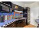 Well-equipped kitchen with stainless appliances, stylish black cabinets, and colorful backsplash at 2201 N Central Ave # 3D, Phoenix, AZ 85004